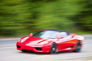 Red sports car driving fast