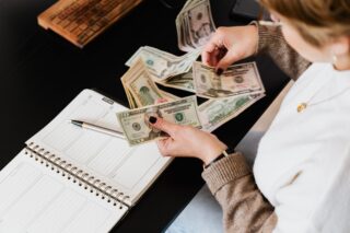 Counting cash to meet obligations.